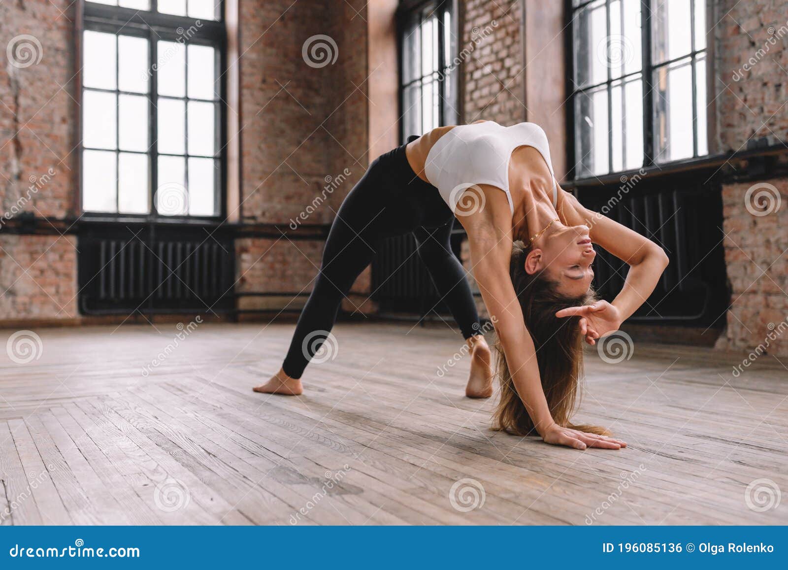 Young Attractive Woman Practicing Yoga At Home, Stretching In Camatkarasana  Exercise, Wild Thing, Flip-the-Dog Pose, Working Out, Wearing Sportswear,  Black Shorts, Top, Full Length, Studio Background Stock Photo, Picture and  Royalty Free