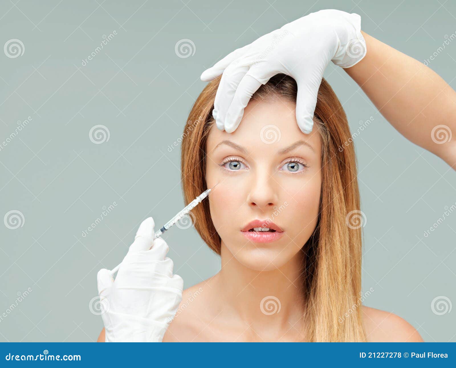 Young woman with doctor hands injecting botox. Beautiful young woman botox injection eye wrinkles