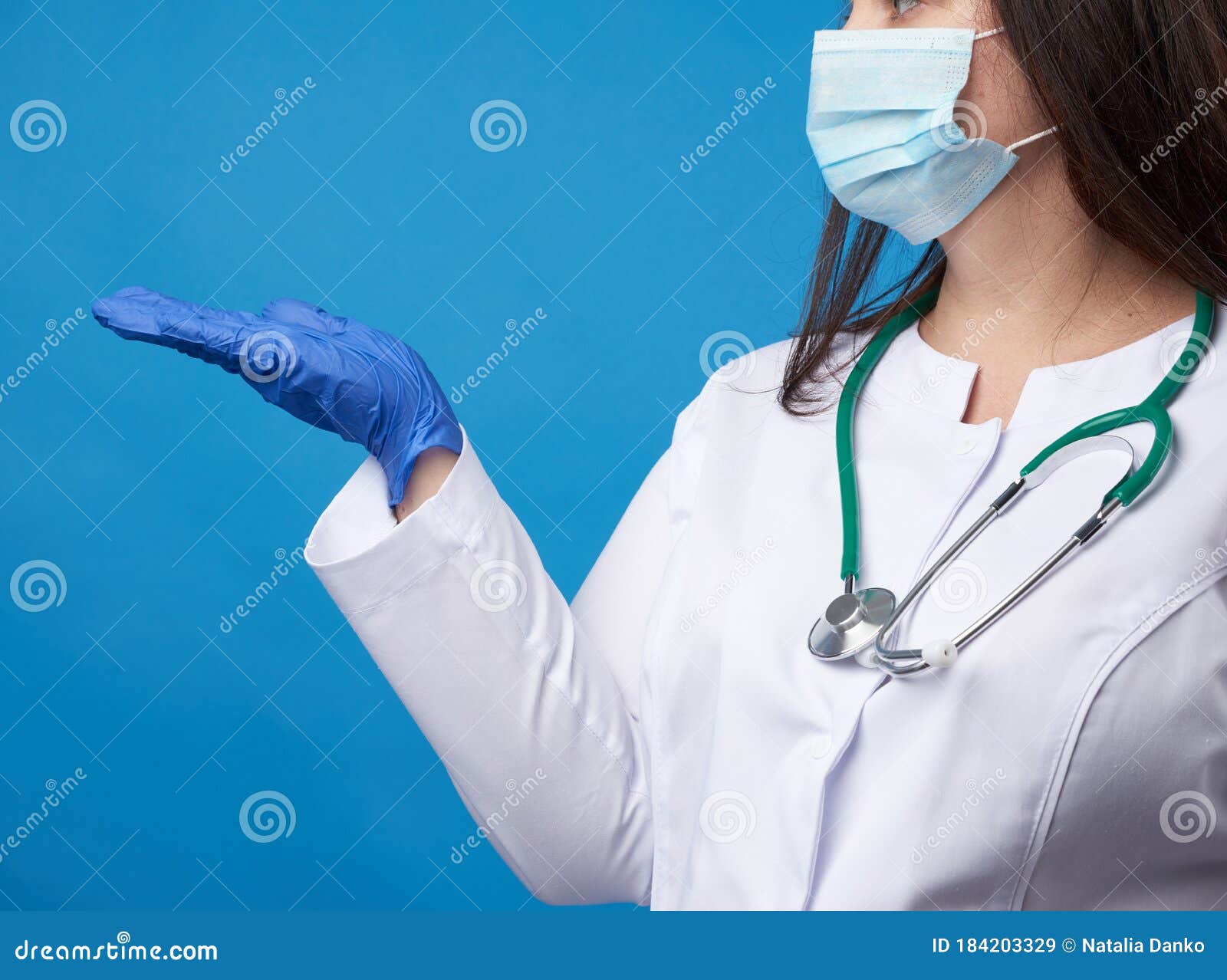 Young Woman Doctor In A White Coat Blue Latex Gloves And A P