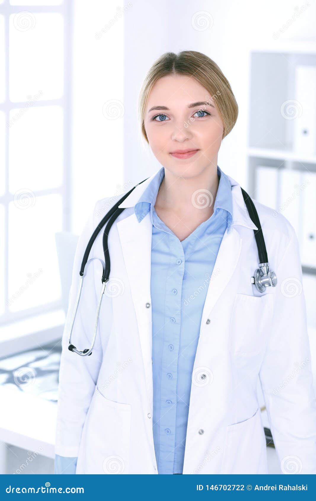 Young Woman Doctor at Work in Hospital Looking at Camera. Blue Colored ...