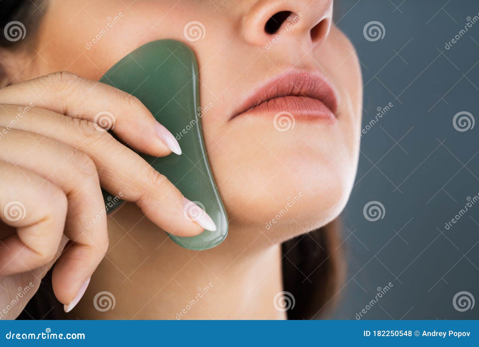 young woman doing gua sha