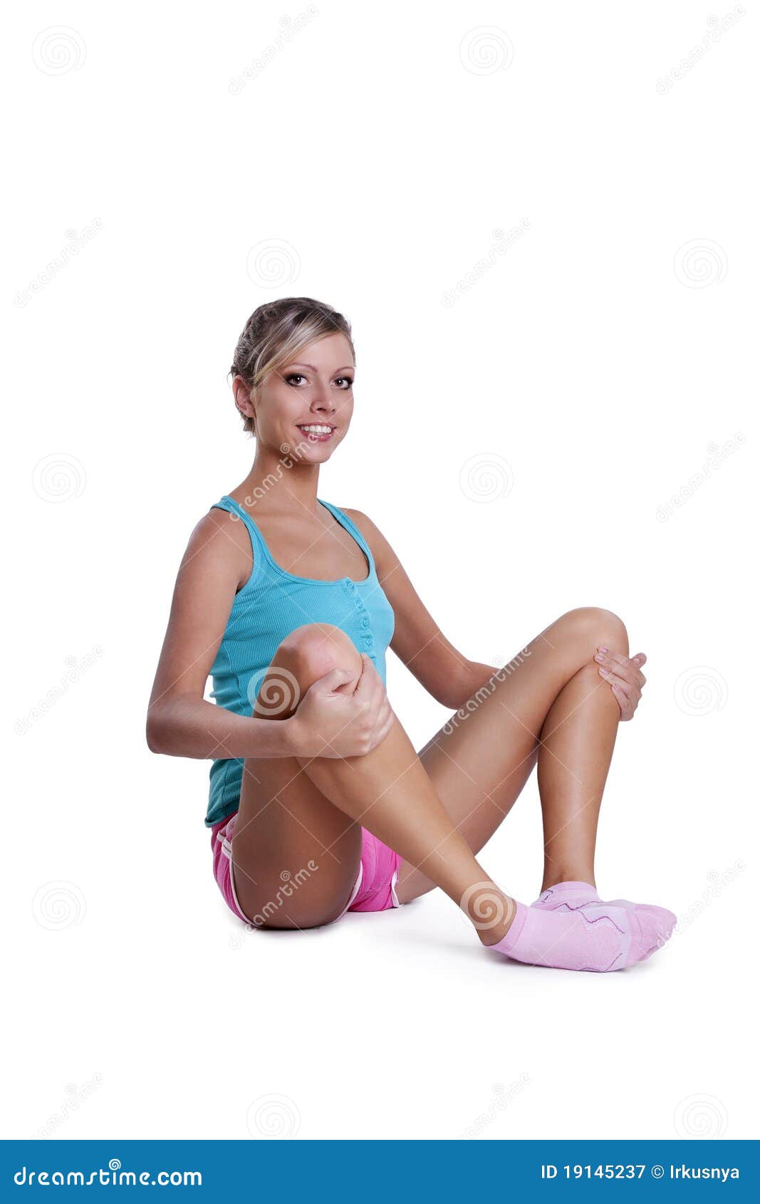 Young woman doing stretching exercises. Young fitness woman doing stretching exercises. Isolated on white