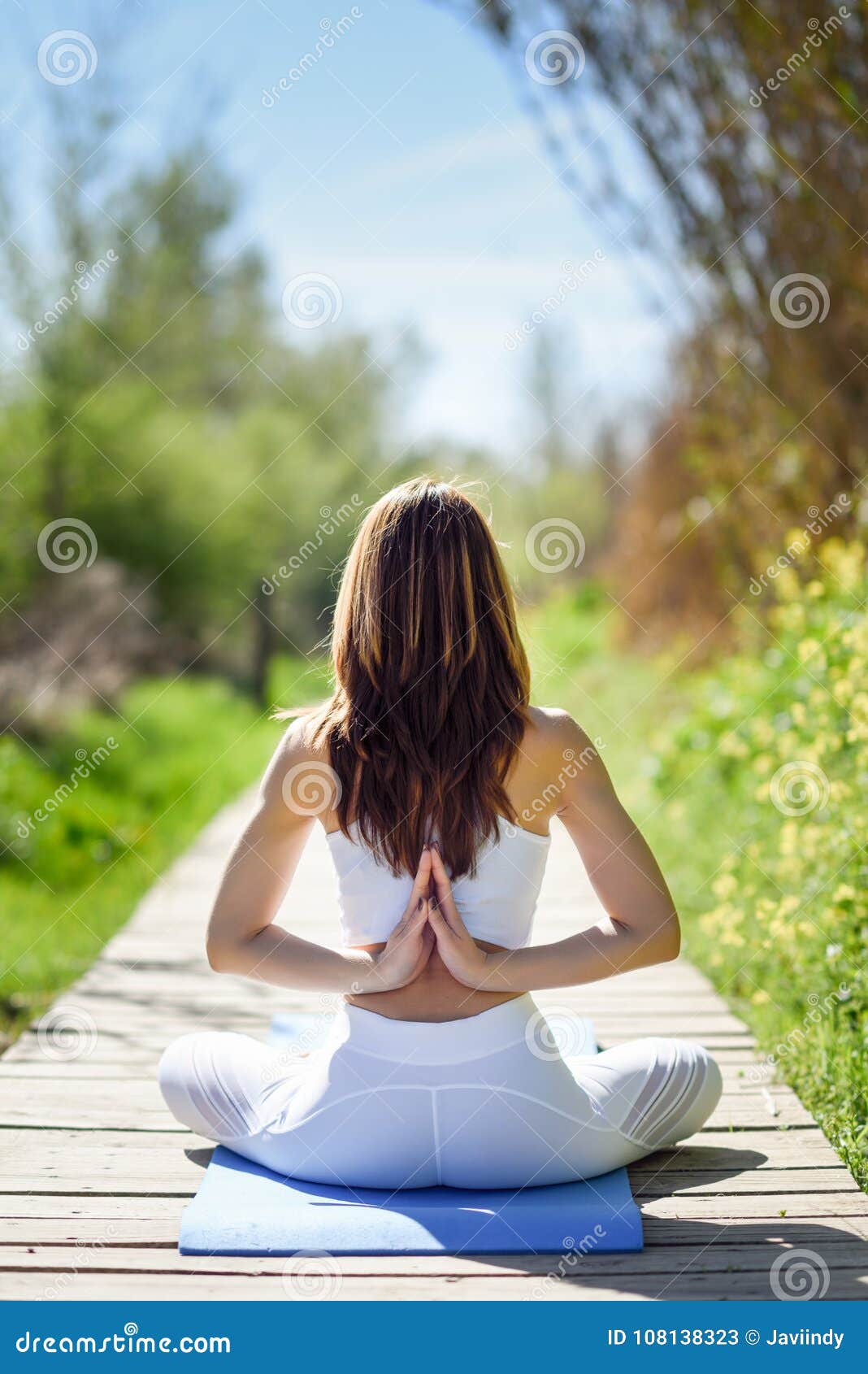 Premium Photo  Woman in white clothes does yoga on a brown background.