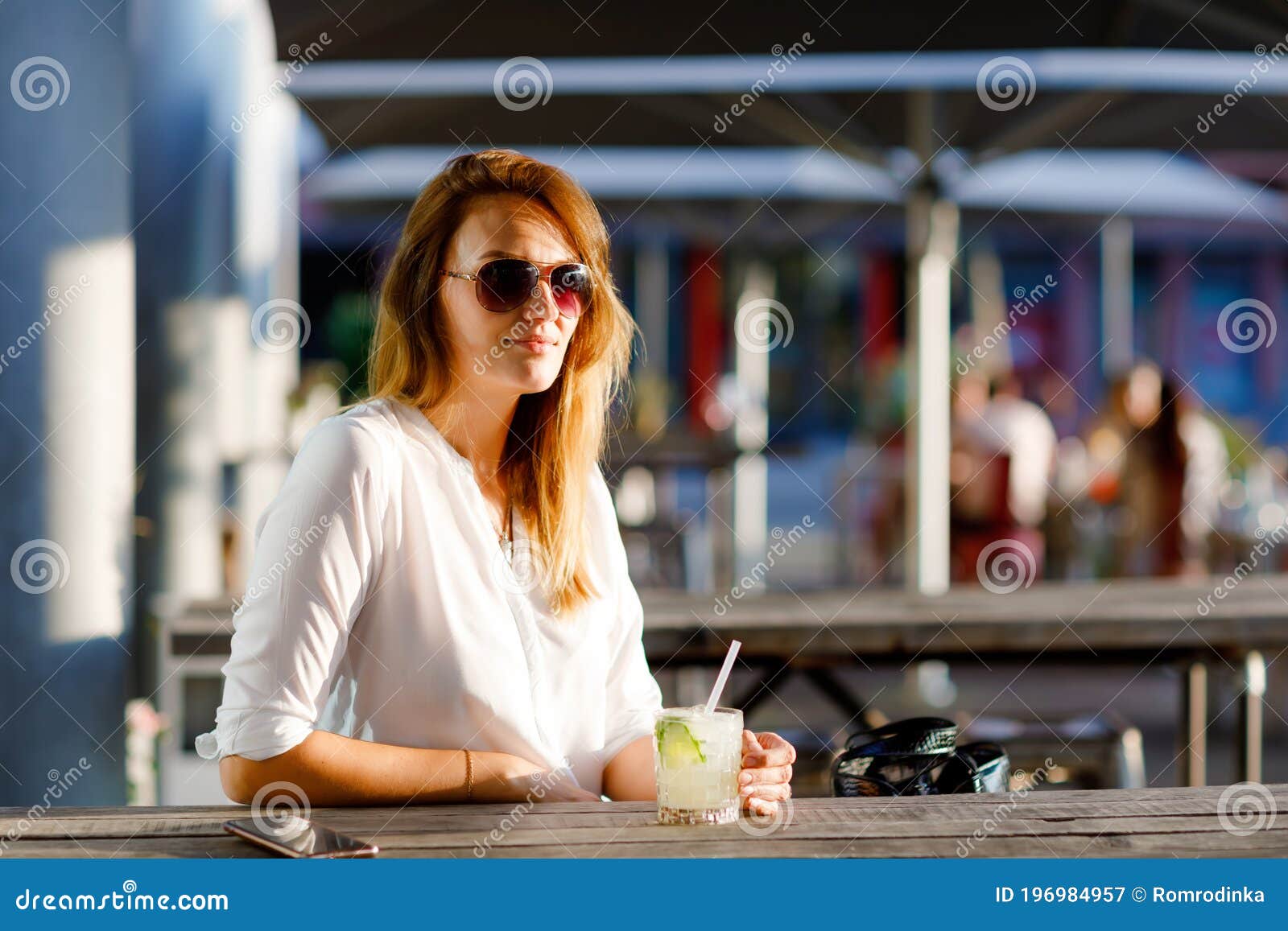 Young Woman Drinking Mojito Cocktail at Cafe Terrace at Hot Summer Day ...