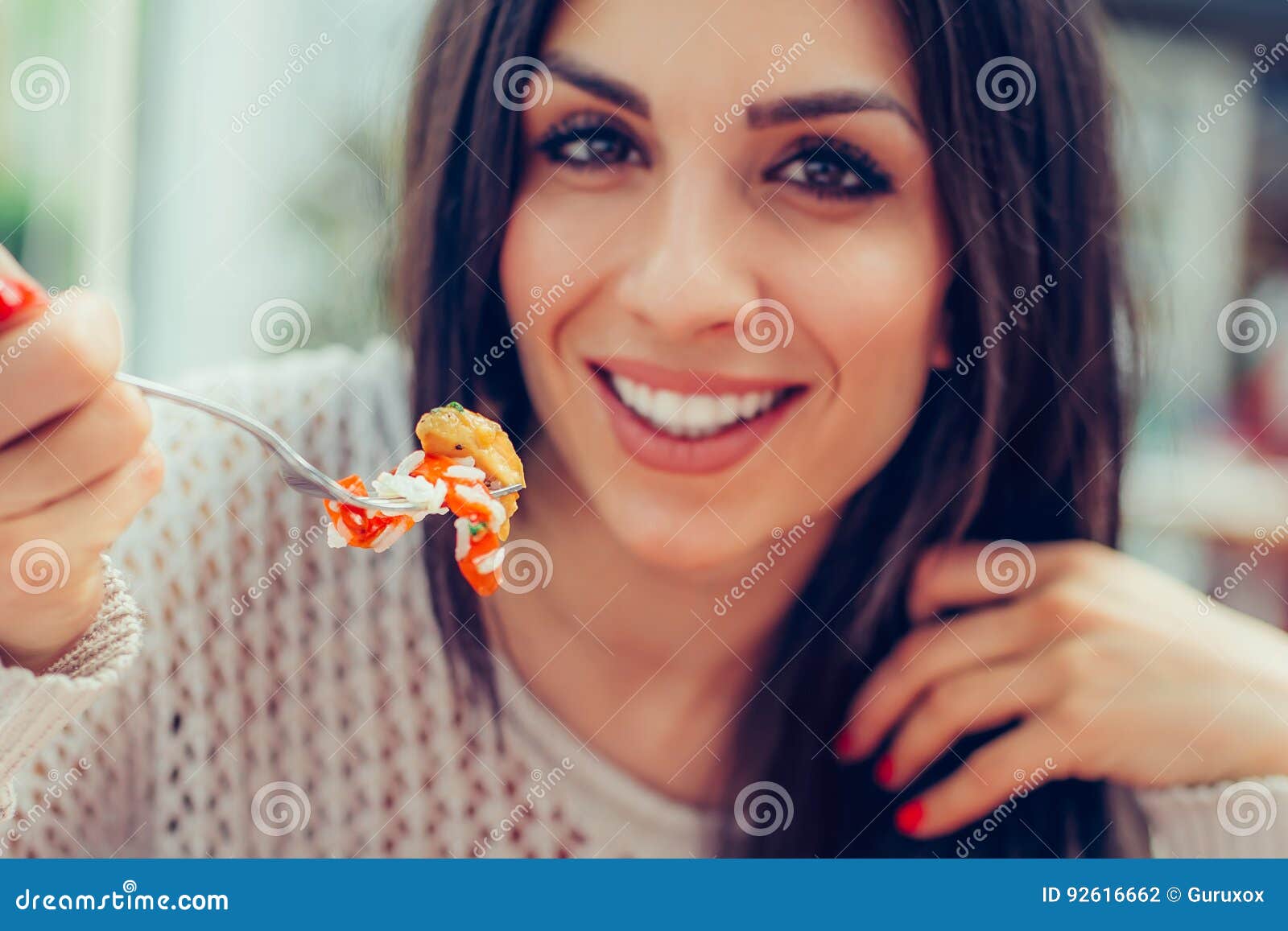 Young Woman Eating Chinese Food In A Restaurant Having Her Lunch Break
