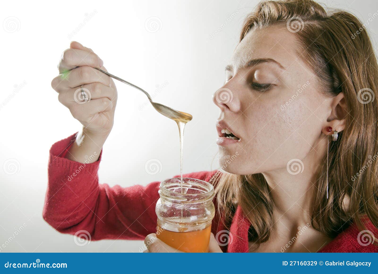 Young woman eating honey stock image. Image of happy 27160329