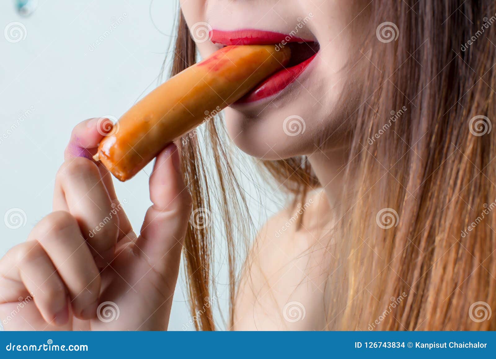 woman eating sausage