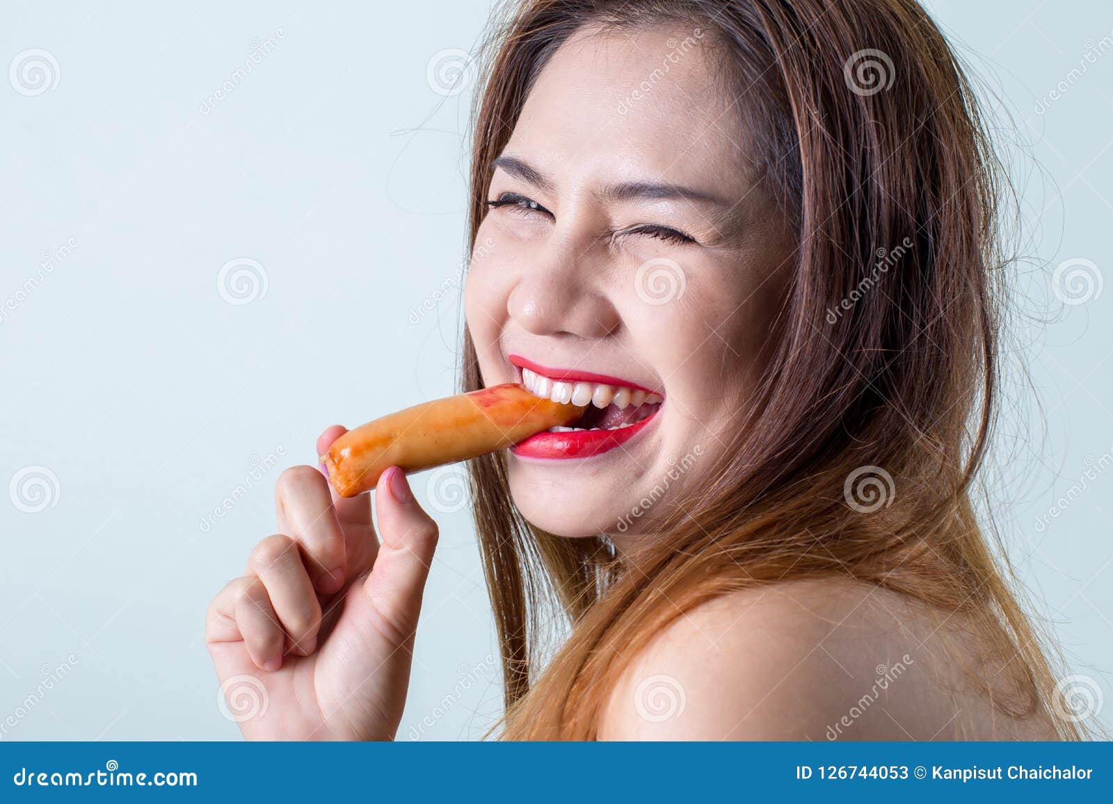 woman eating sausage