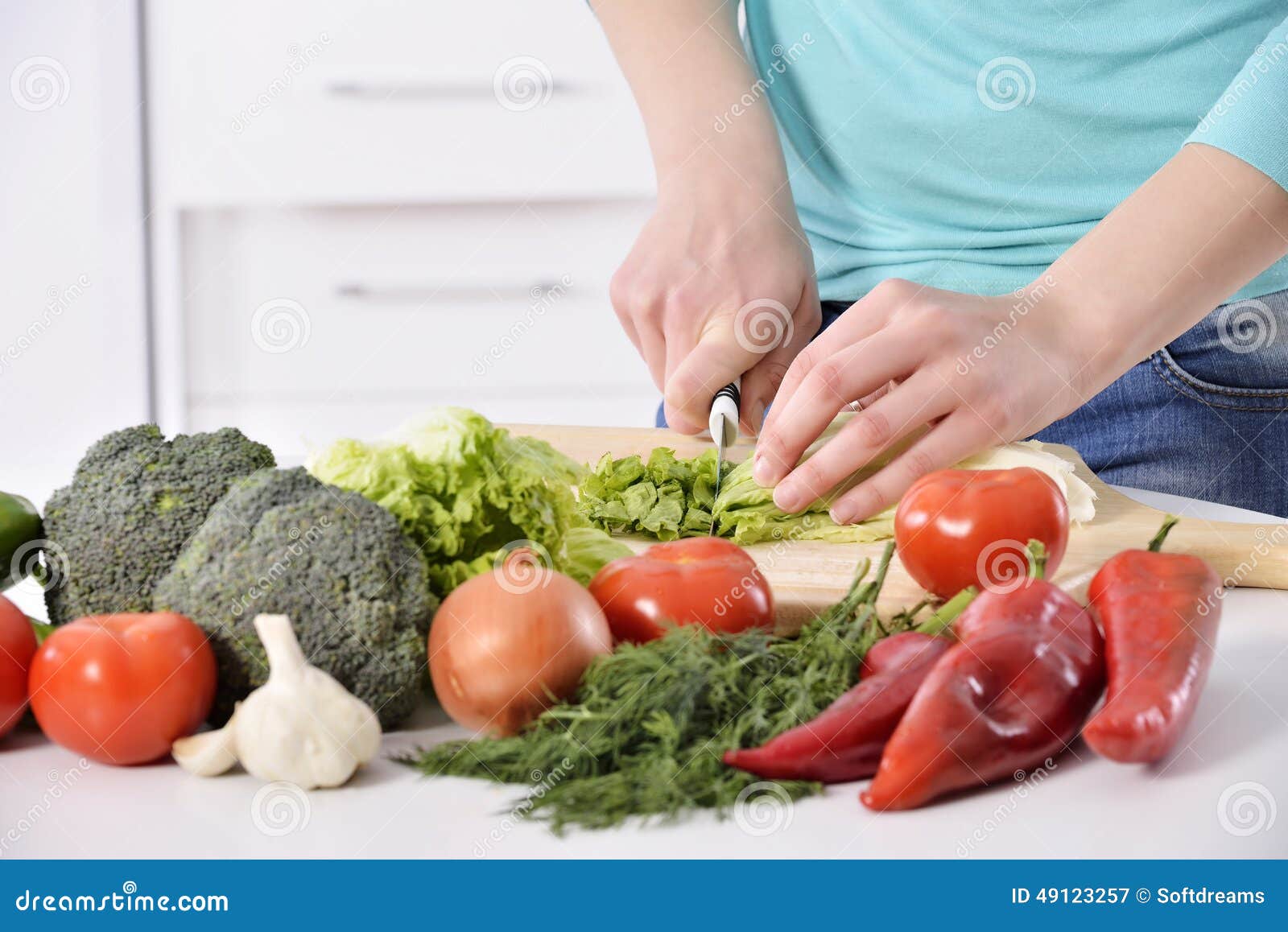 woman cooking in new kitchen making healthy food with vegetables.