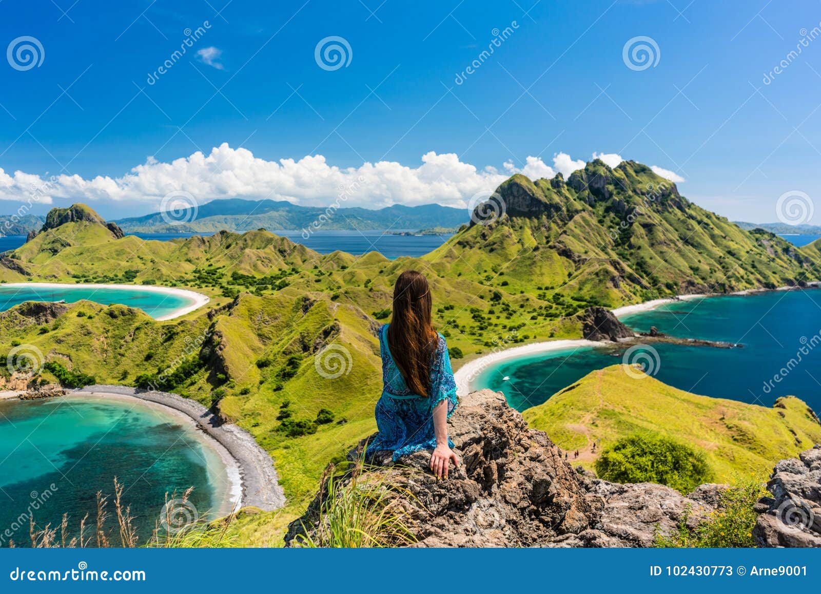 young woman enjoying the awesome view of padar island during sum