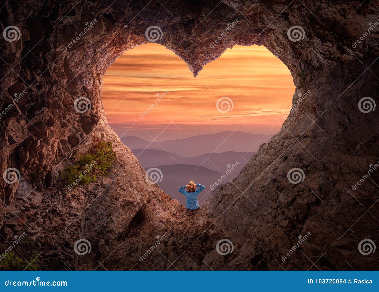 Woman in Heart Shape Cave Towards the Vast Landscape Stock Photo ...