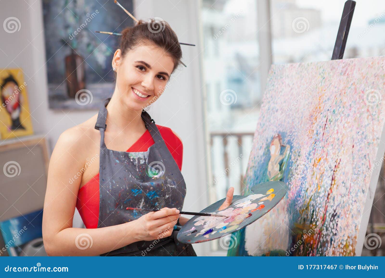 Young Woman Enjoying Painting At Her Art Studio Stock