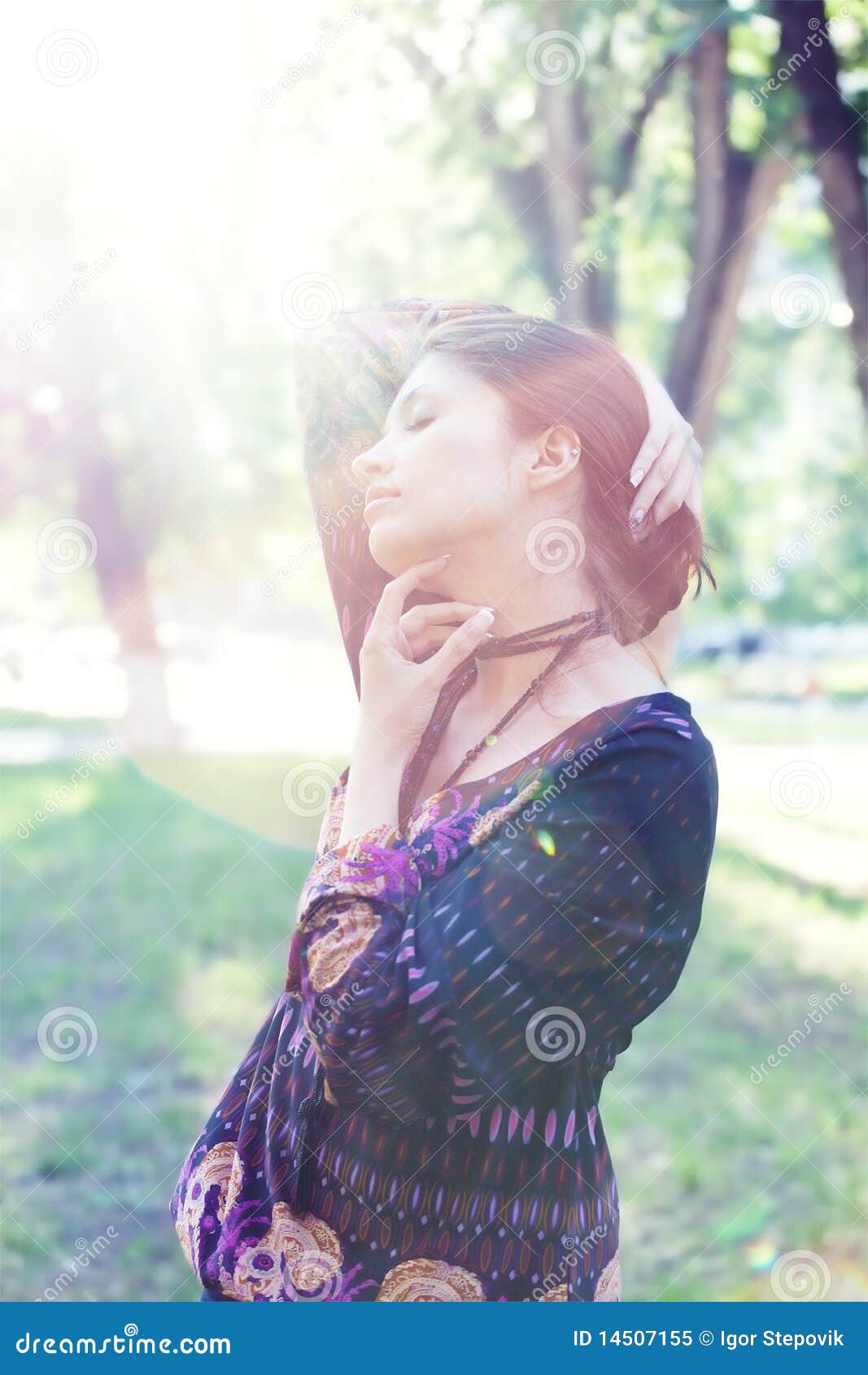 young woman enjoys sun beams at spring park