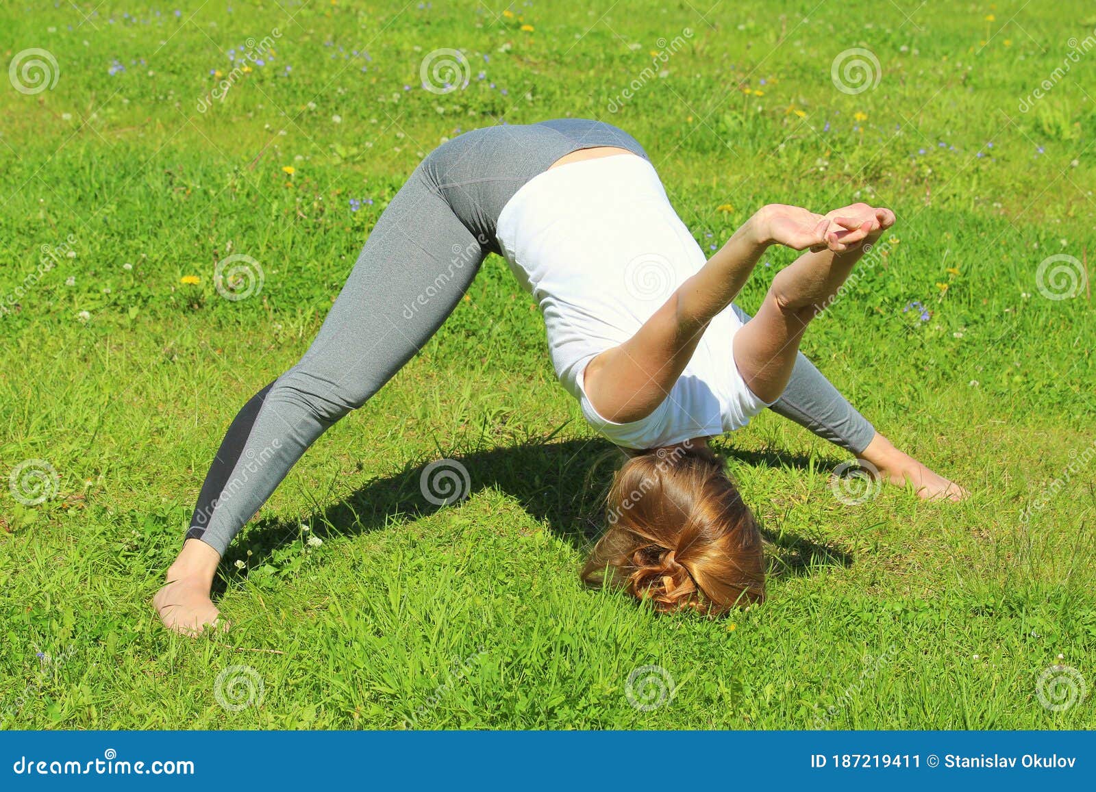 young woman of european appearance does yoga in summer nature