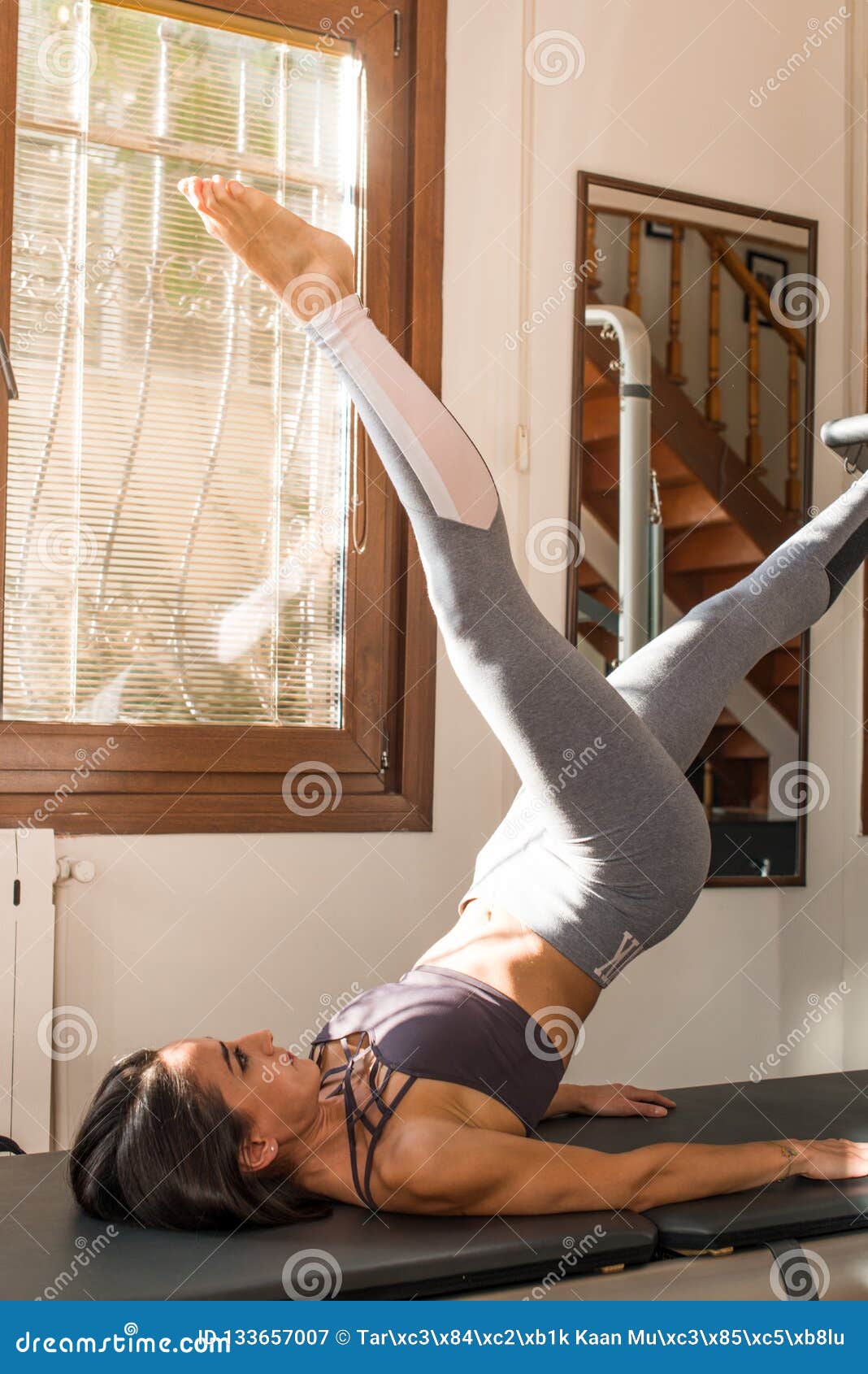 https://thumbs.dreamstime.com/z/young-woman-exercising-pilates-reformer-pilates-instructor-cadillac-reformer-workout-peak-pilates-pilates-trainer-133657007.jpg