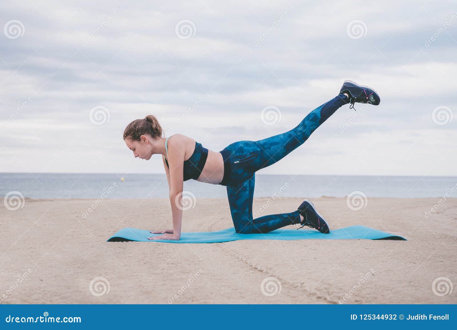 young woman fitness on the beach.