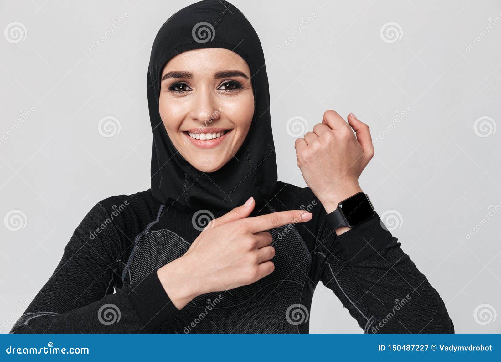 Young Woman Fitness Muslim Using Watch Clock Isolated Over White Wall