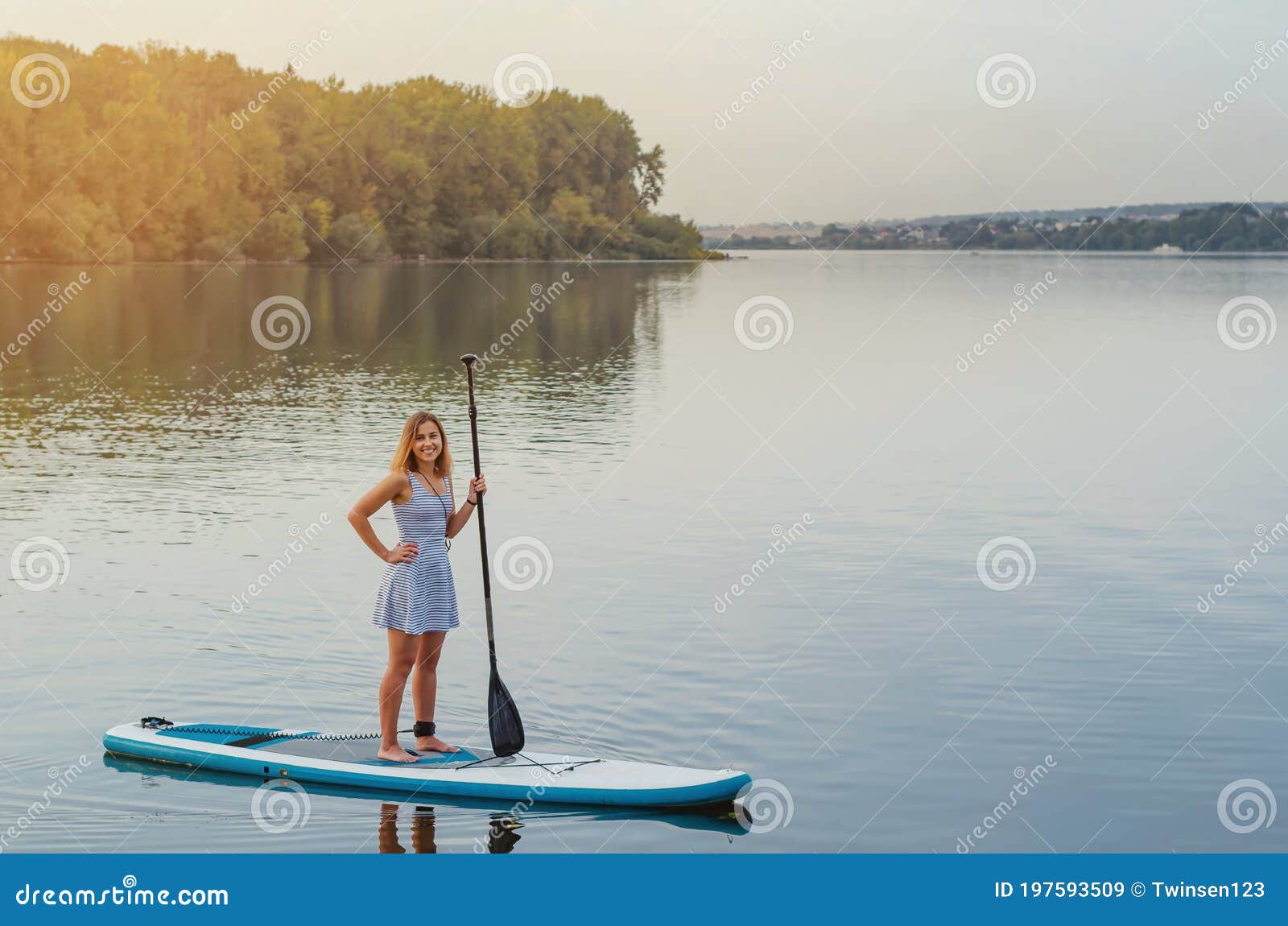 Young Woman Floats on the Water of the Lake on a Sap Board with an Oar ...