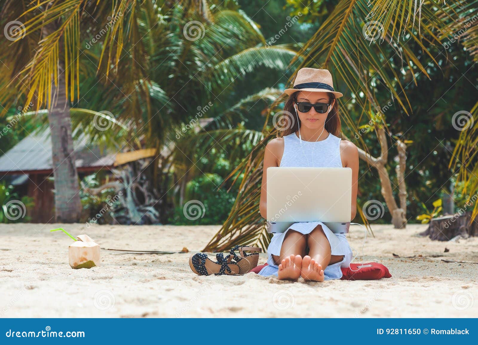 young woman freelancer working in laptop on the beach. freelance work