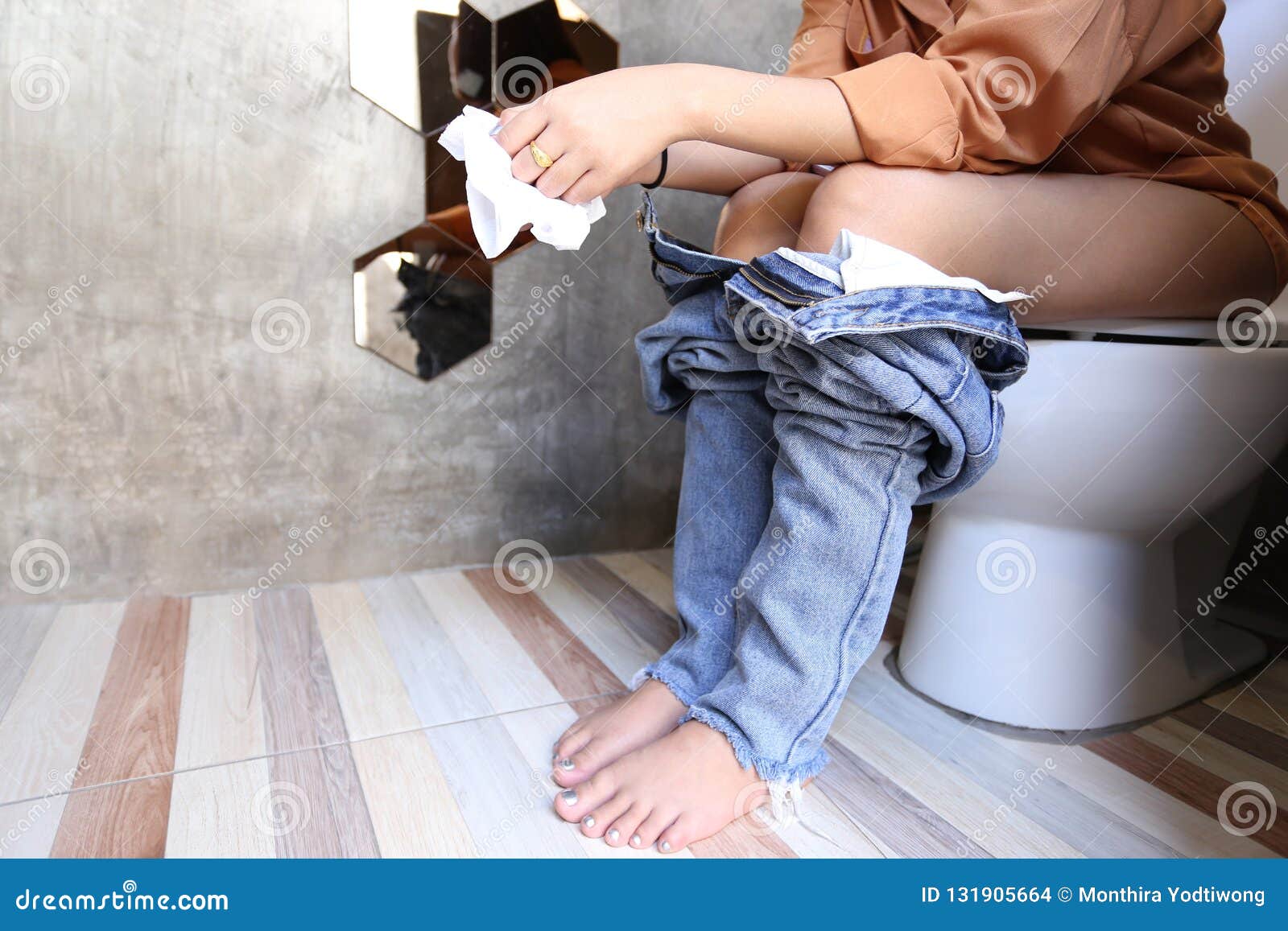 Japanese girl in jeans pissed over the toilet bowl