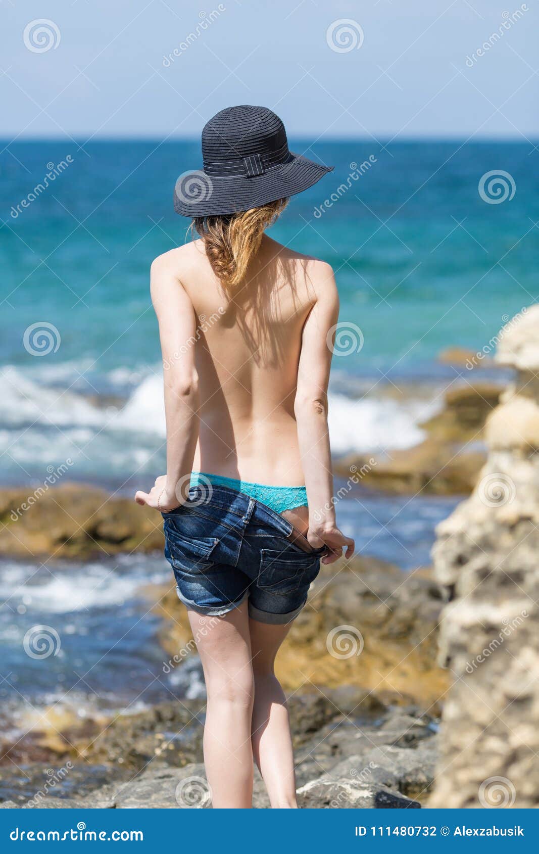 Girls indressing at nude beach Young Woman In Hat And Shorts Undressing On Seashore Stock Photo Image Of Rear Jeans 111480732