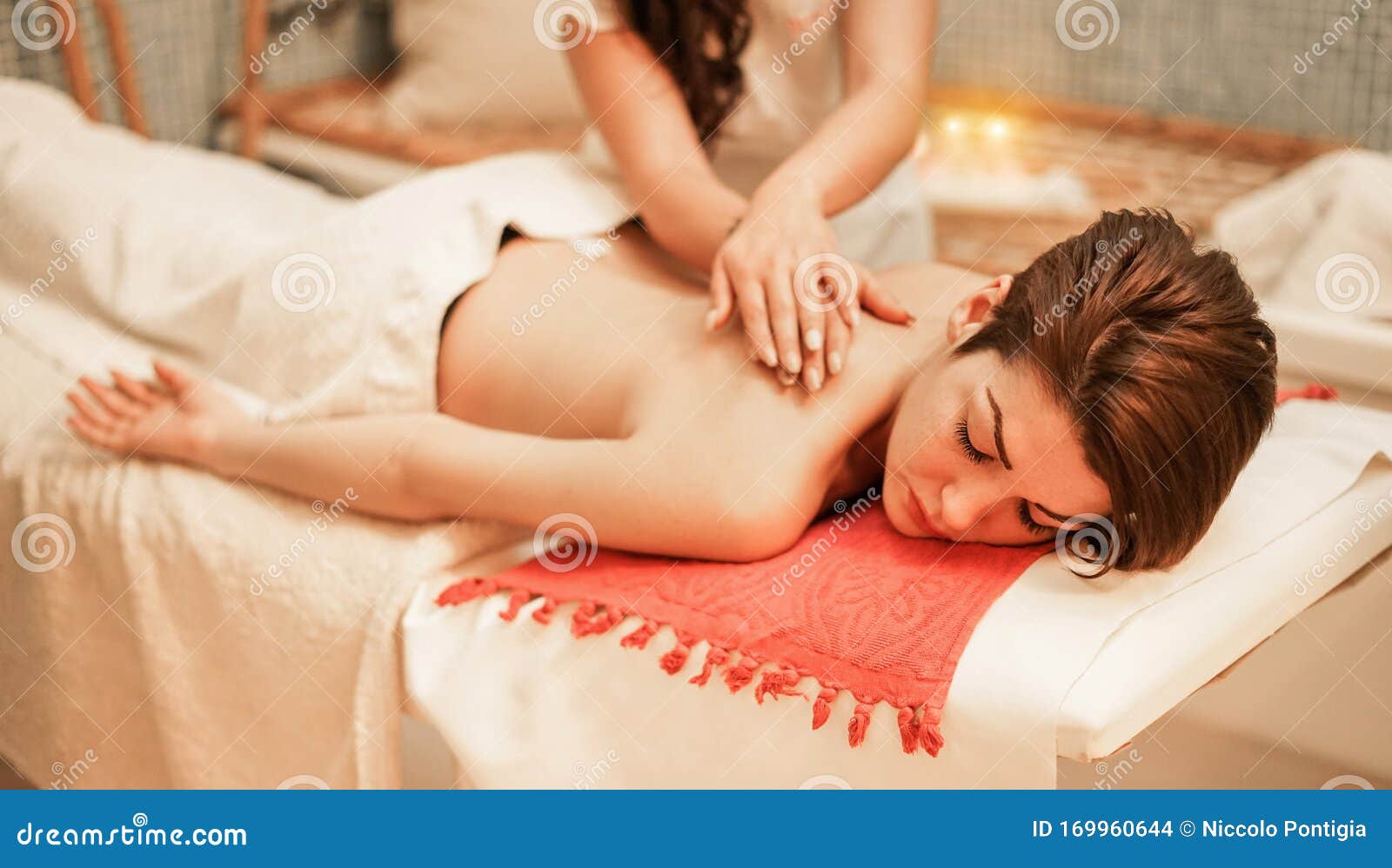 Body care. Relaxed woman enjoying back massage Stock Photo by