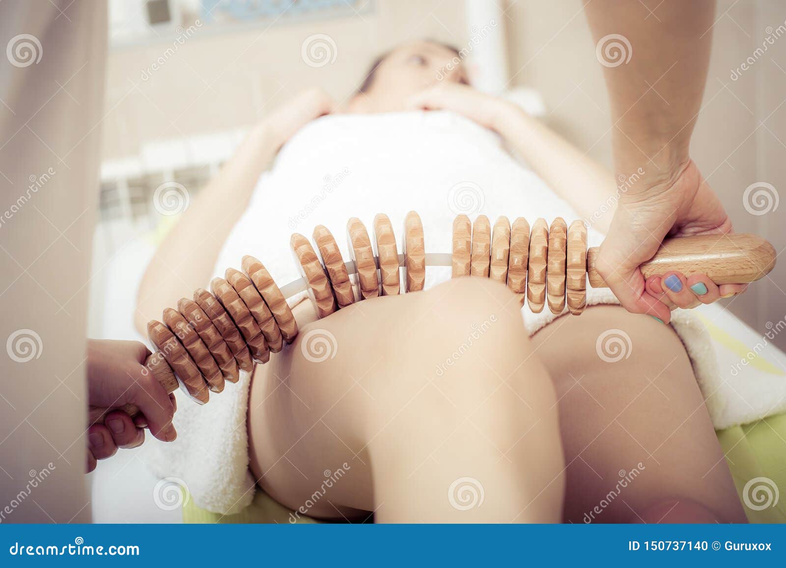 young woman having a maderotherapy massage treatment at spa salon
