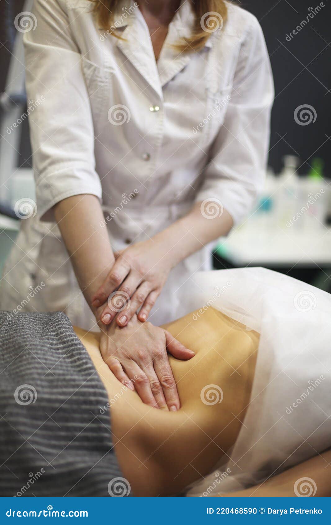 young woman having stomach massage