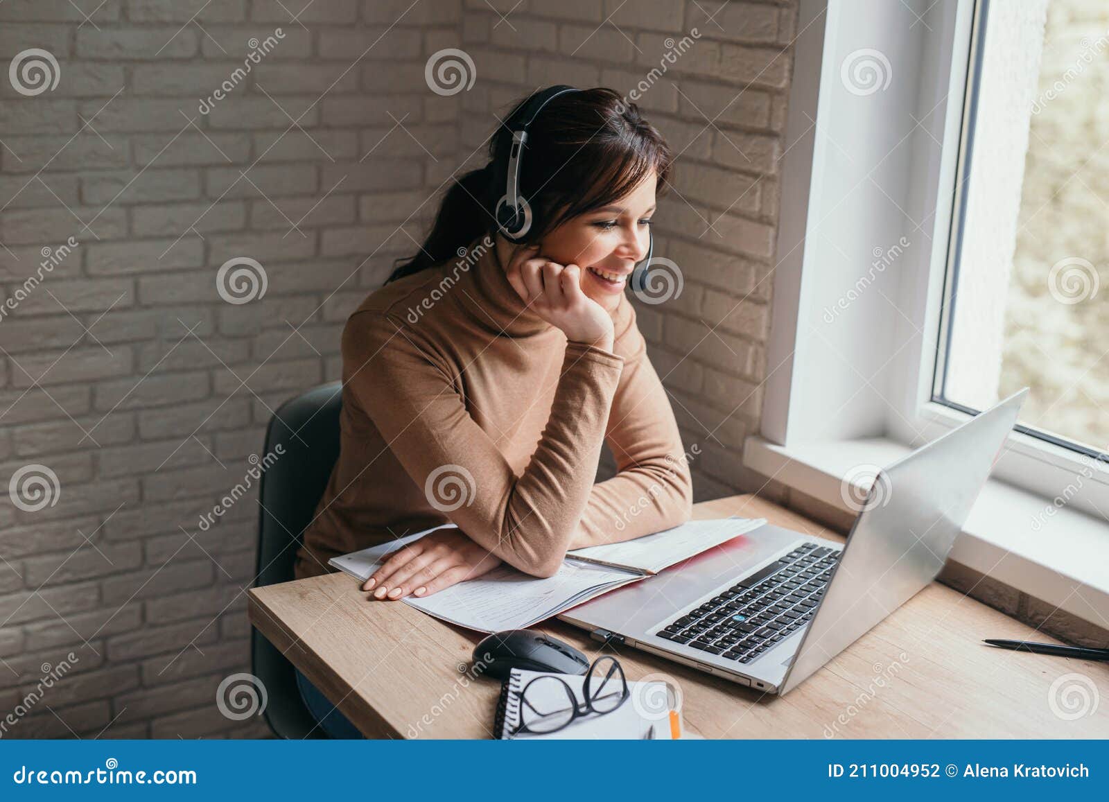 young woman having zoom video conferencing call via computer. home office. stay at home