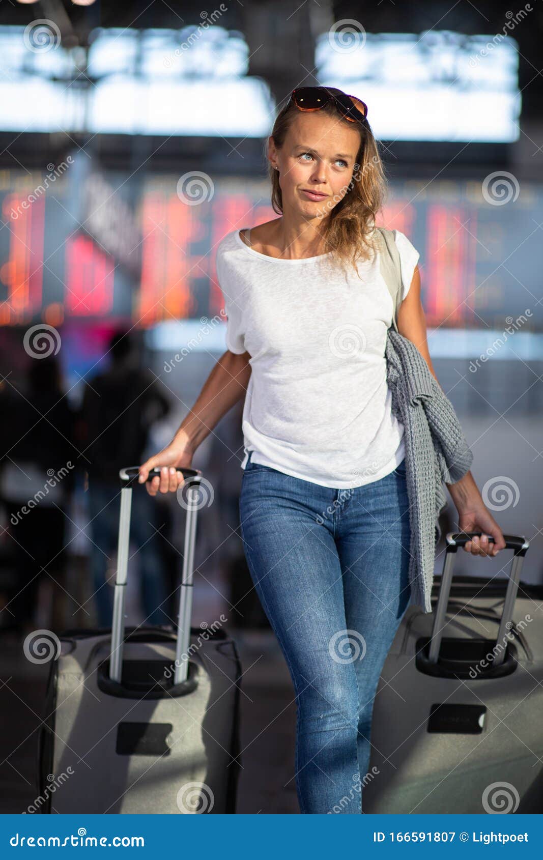 young woman with her luggage at an international airport