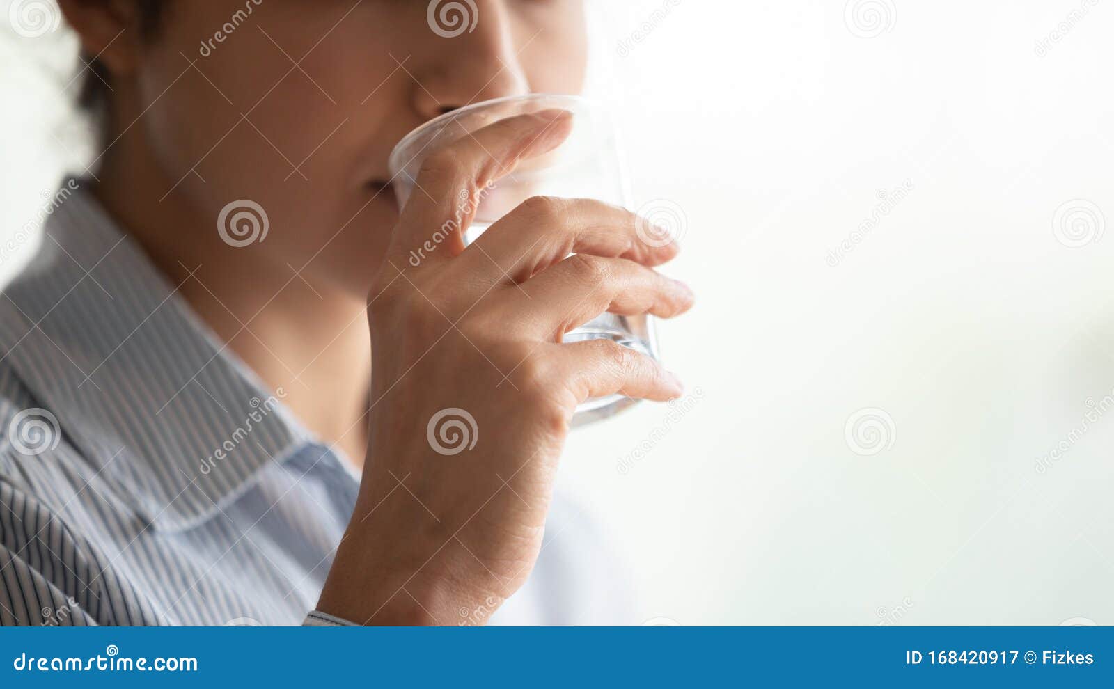 young woman holding glass sip filtered mineral water, close up