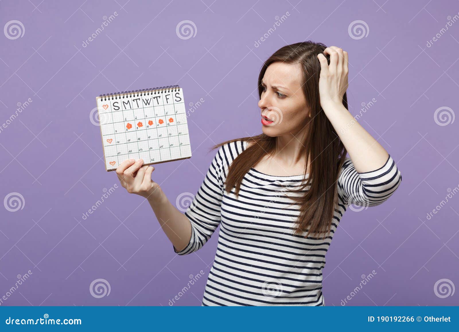 Young Woman Holding In Hand Female Periods Calendar For Checking