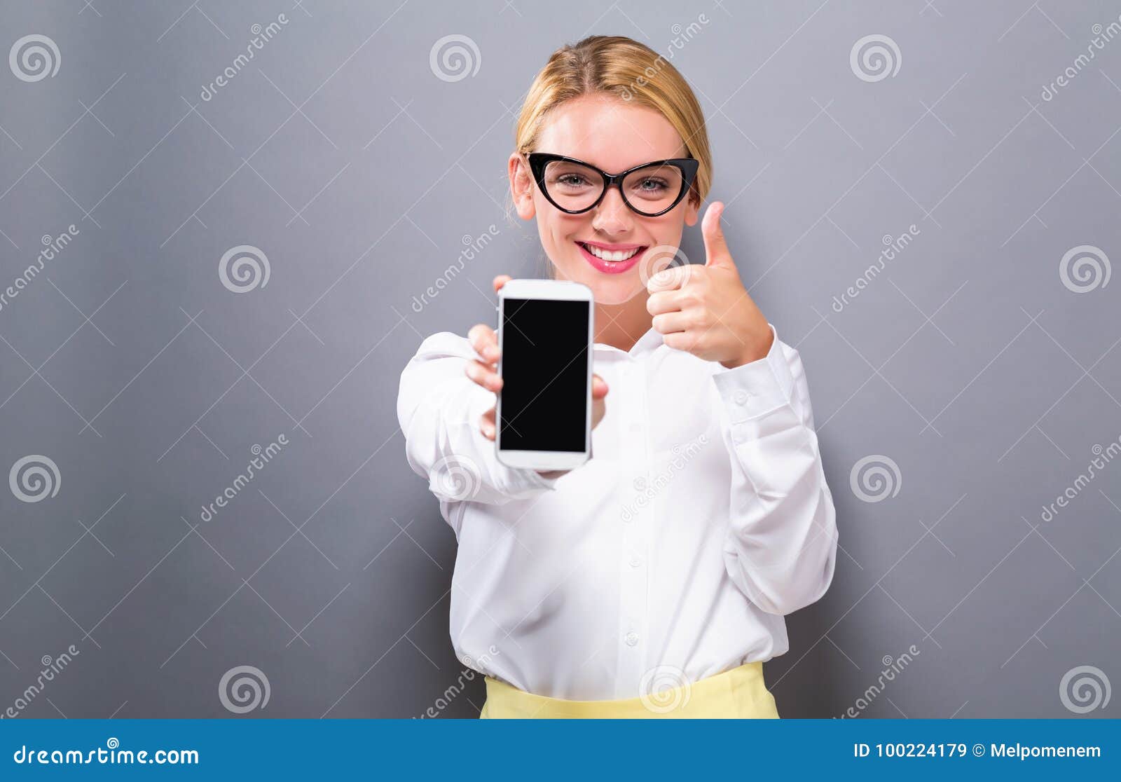 young woman holding out a cellphone