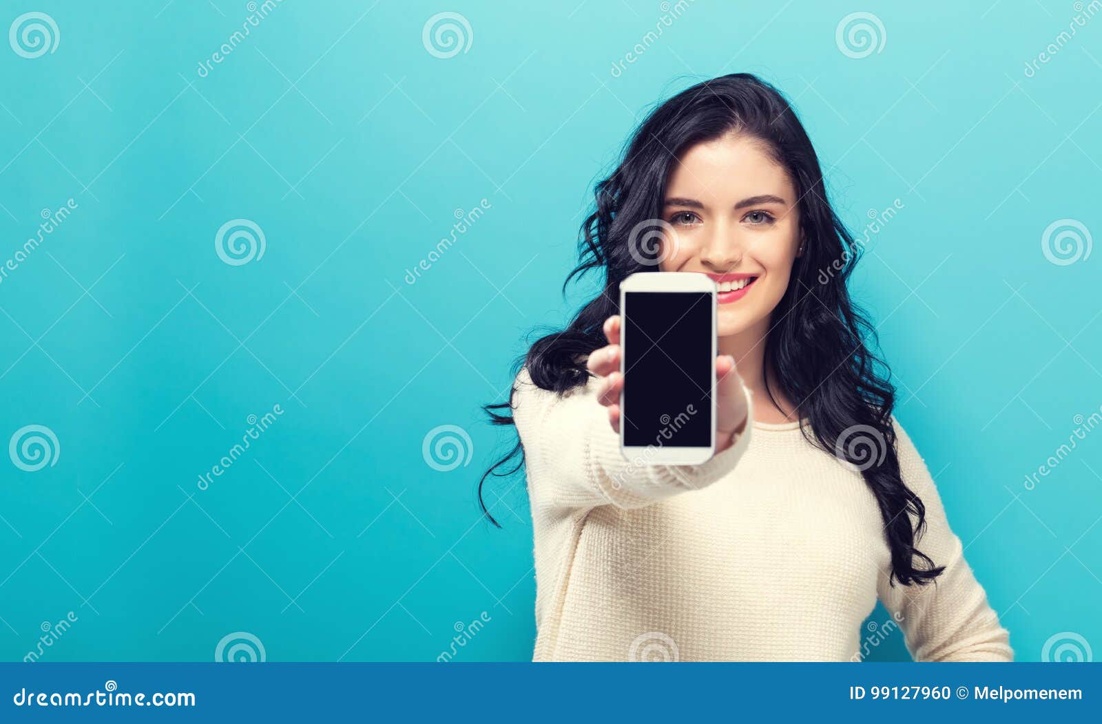 young woman holding out a cellphone