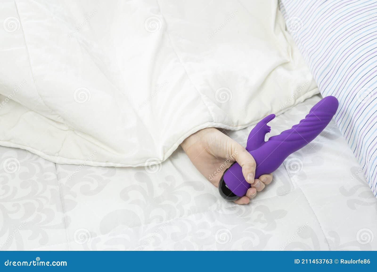 Young Woman Holding Sex Toy in Bed.Pleasure and Sexual Concept Lifestyle with Silicone Vibrator Device Stock Image image