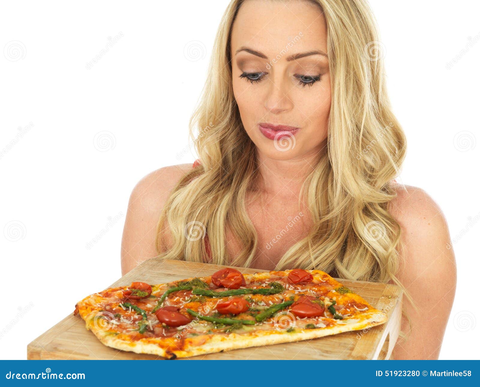 Young Woman Holding a Whole Baked Pizza. A DSLR royalty free image, of an attractive young woman with blonde hair, holding a whole baked pizza, looking surprised happy and thoughtful. Against a white background. With space for text.