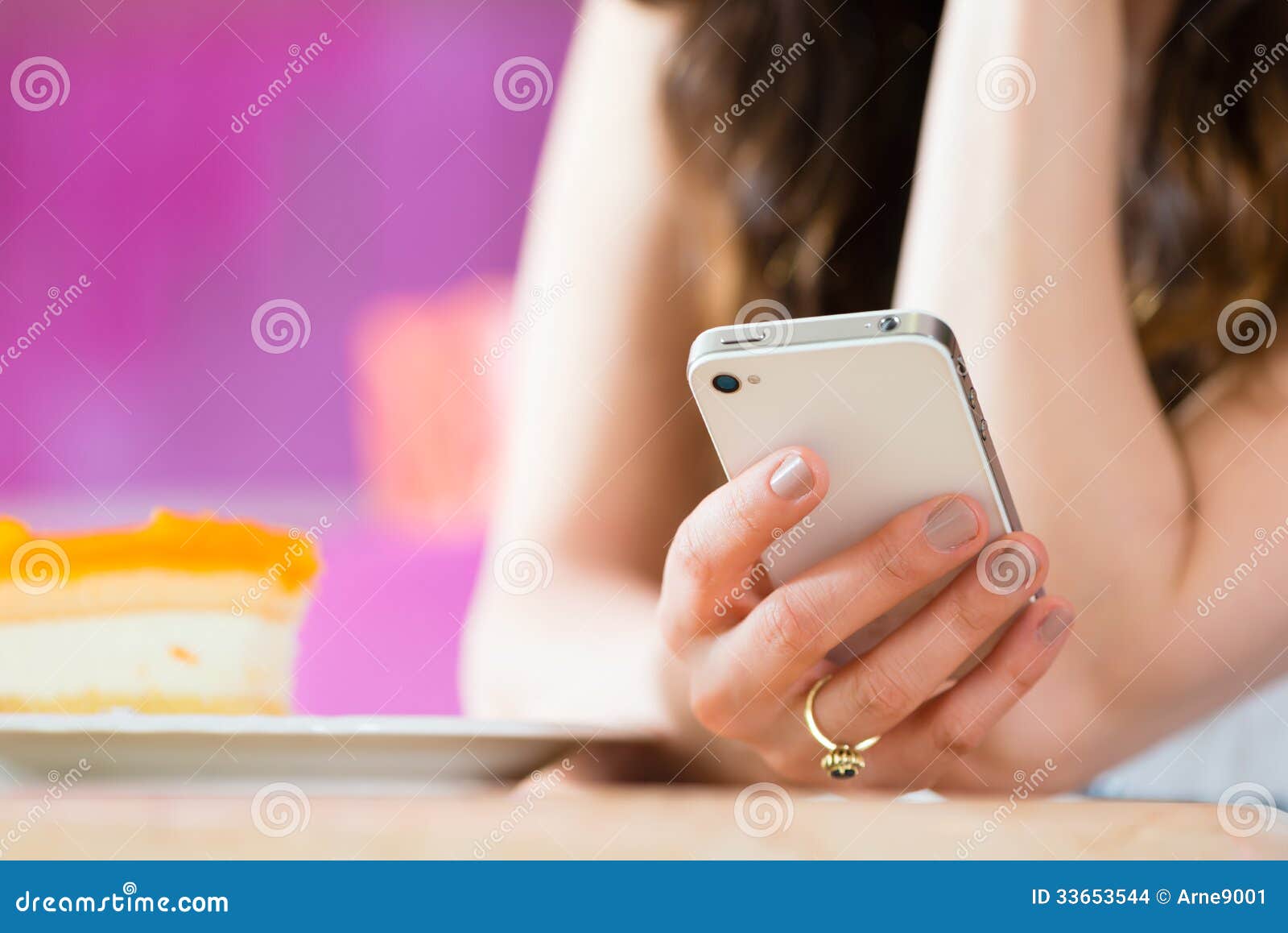 young woman in ice cream parlor with phone texting