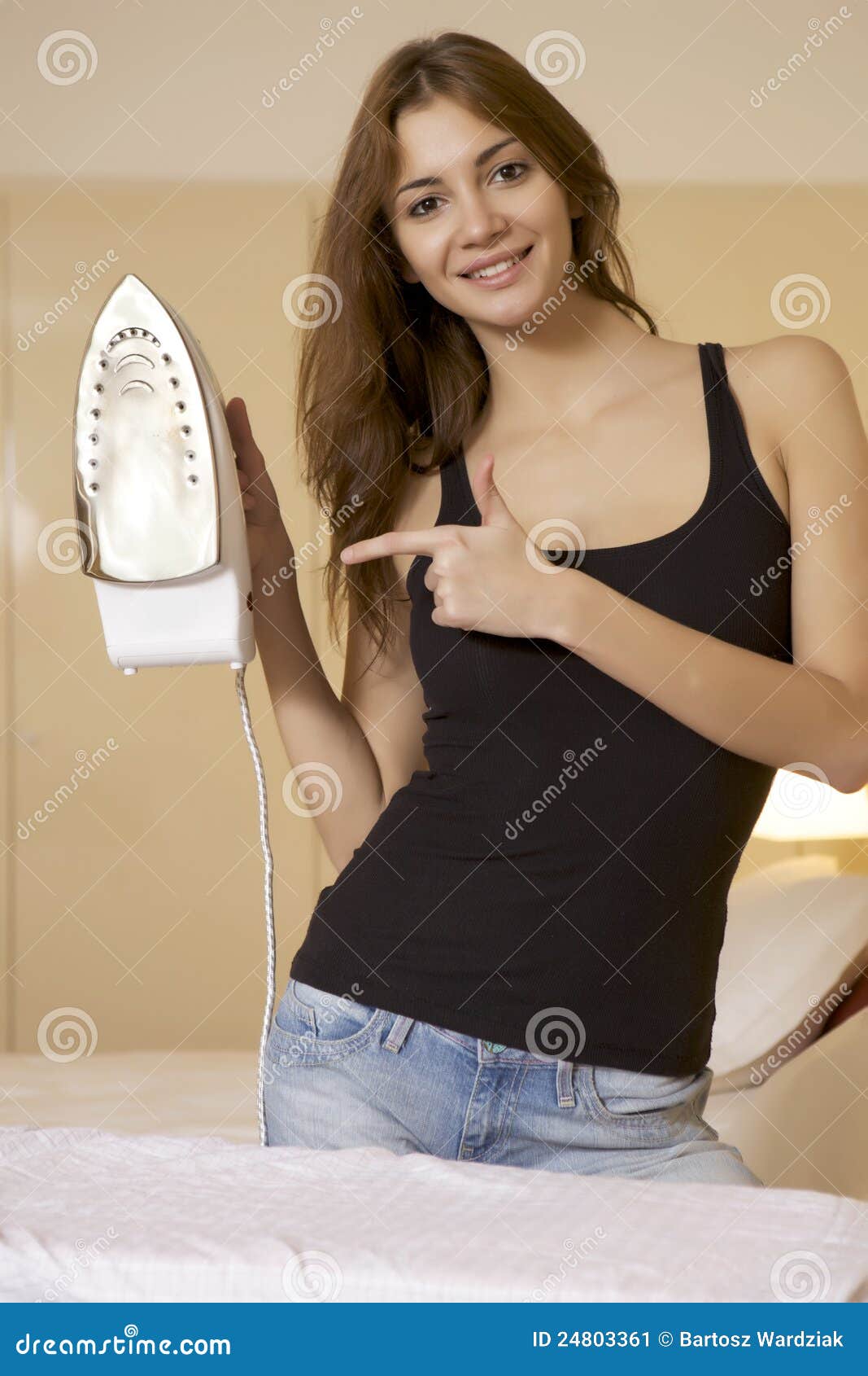 Young Woman Ironing on Ironing Board Stock Image