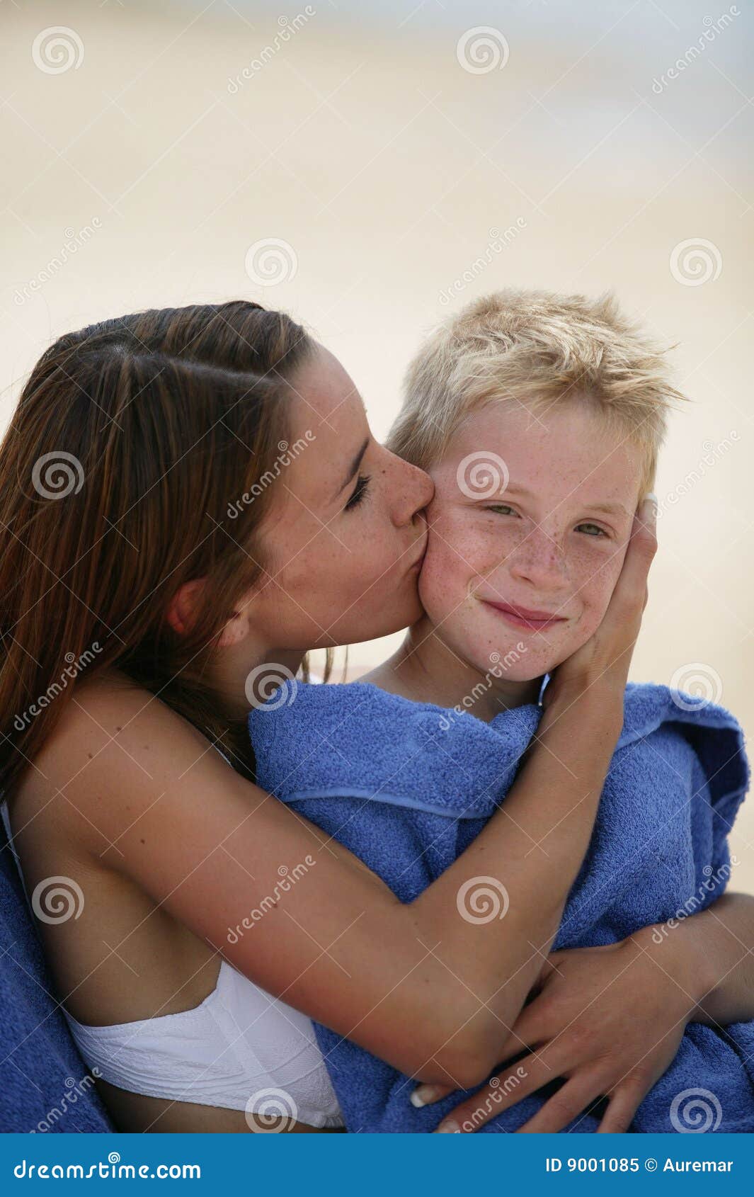 woman kissing boy