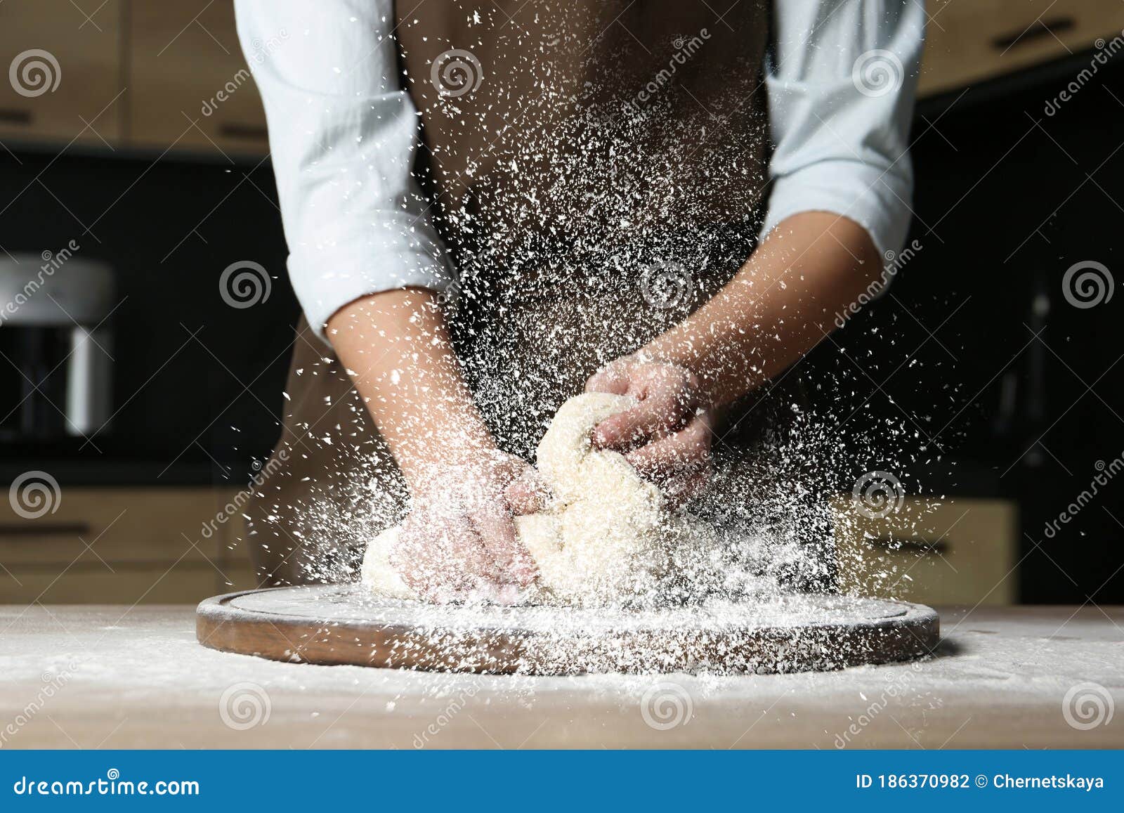 Young woman with deep cleavage kneads dough, Stock Photo, Picture And  Royalty Free Image. Pic. WR2457906