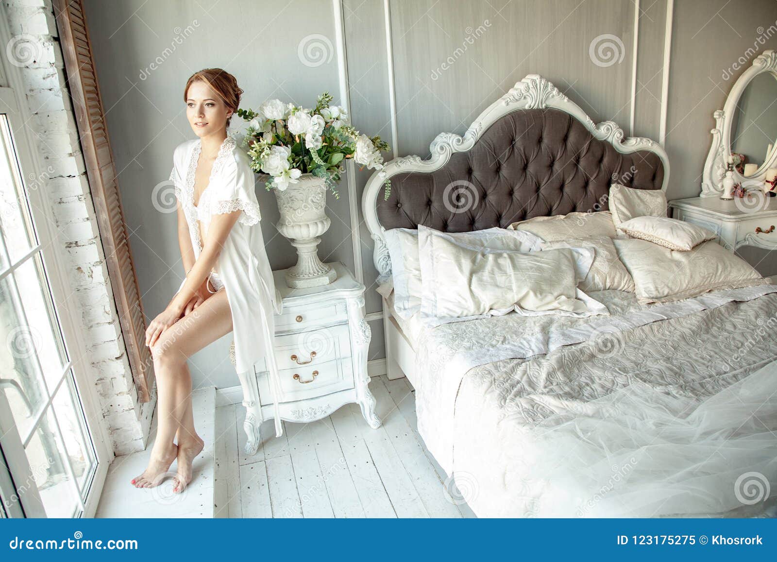 Young Woman In Lace Lingerie Sitting On Bed Cabinet In Luxury In