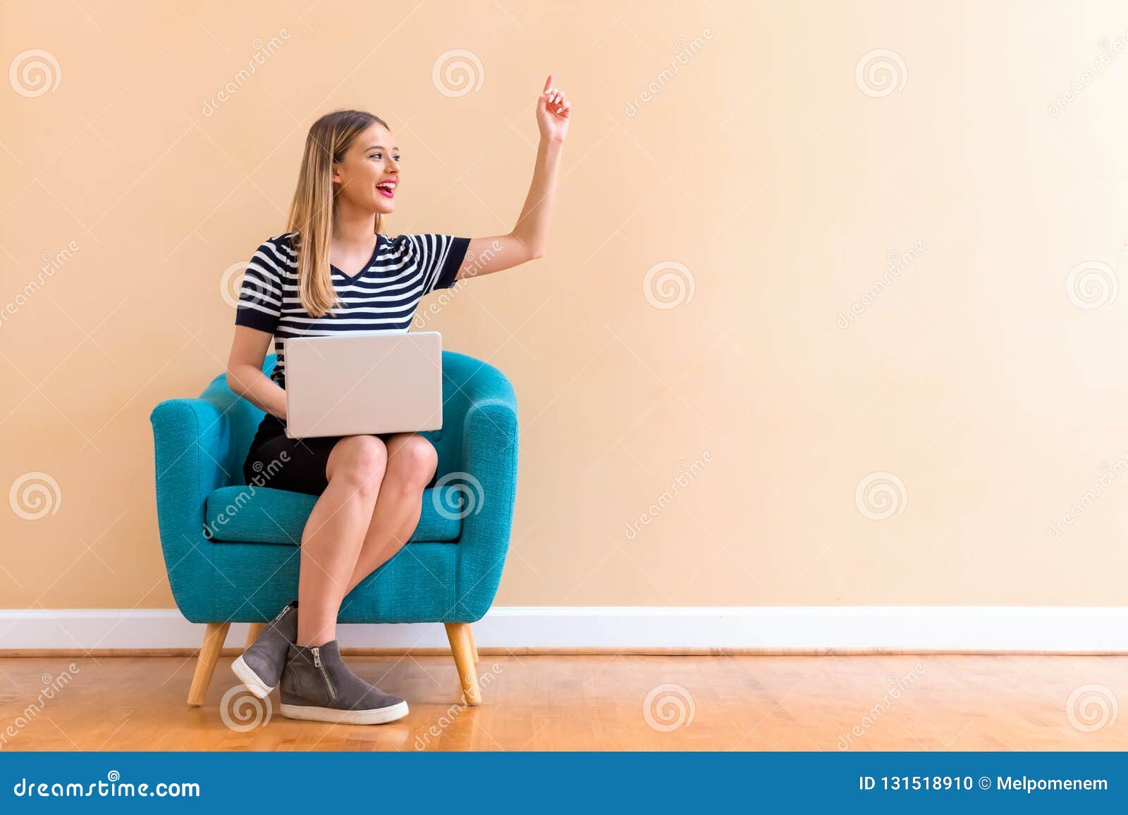 young woman with a laptop computer pointing something