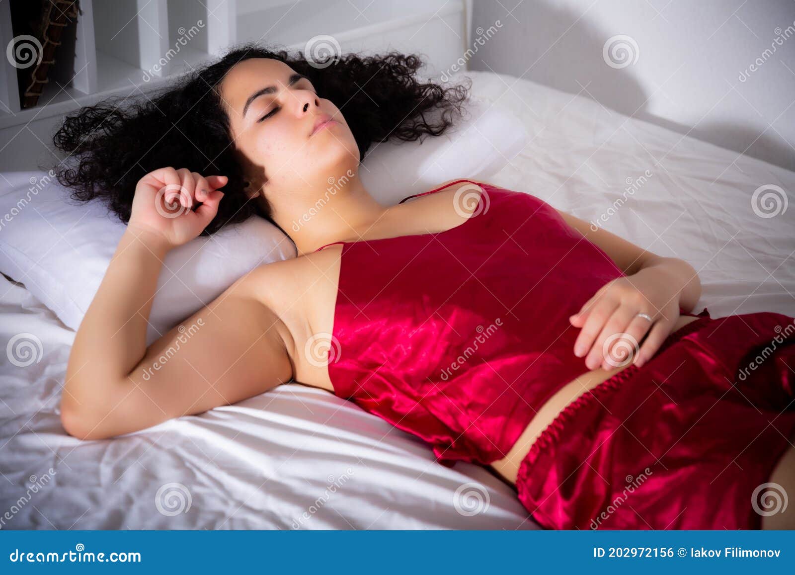 Woman in lingerie sleeping on the bed Stock Photo