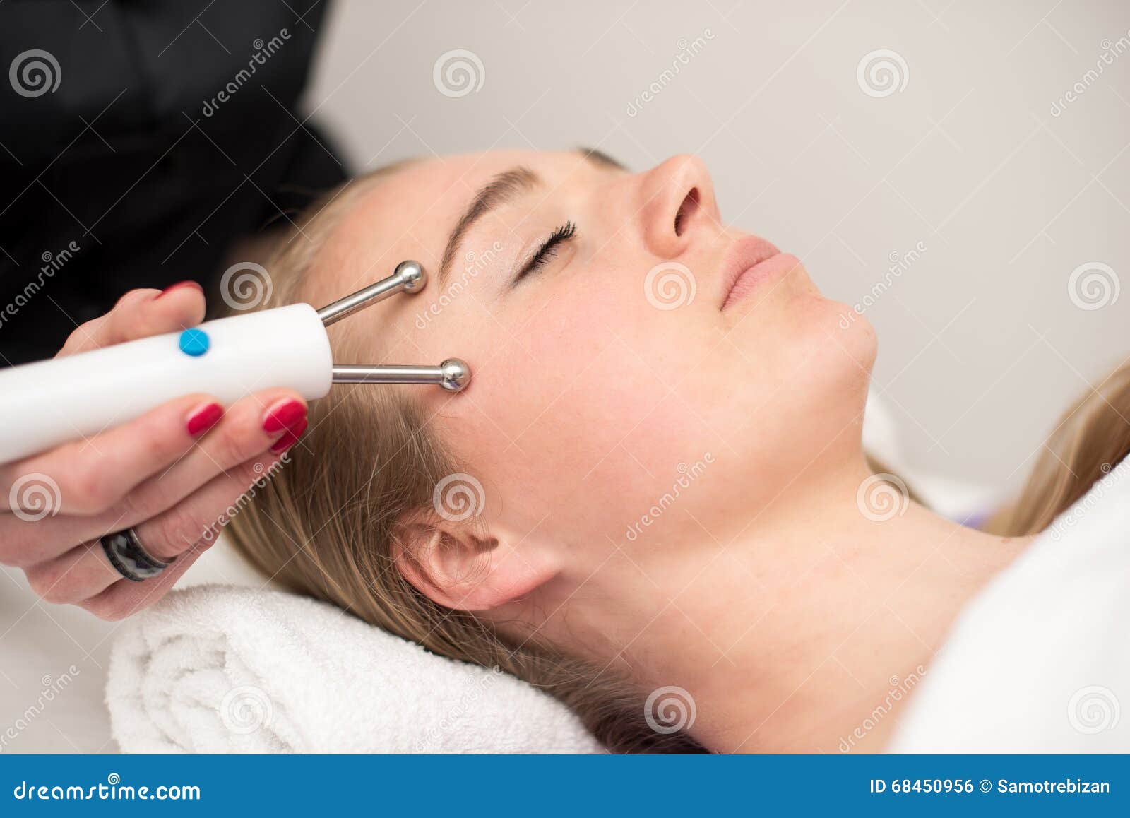 Young Woman Lying On Massage Table Receiving Face Massage Beaut Stock