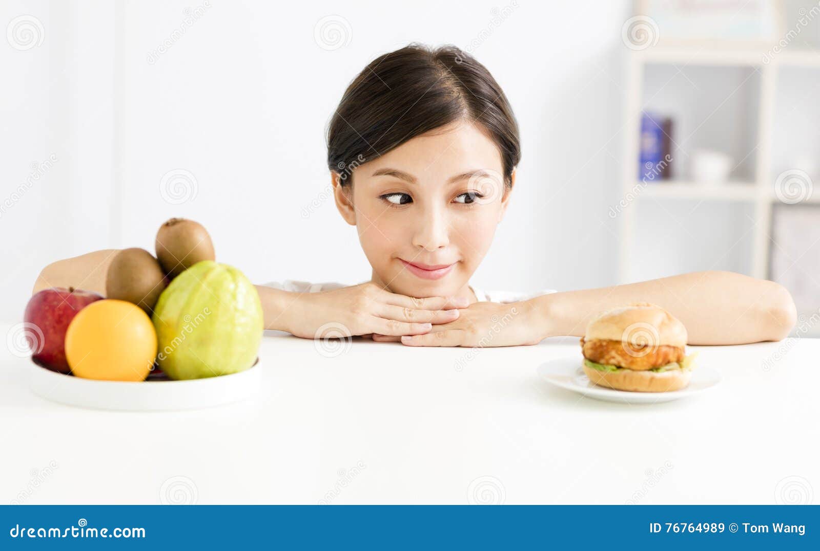 Young Woman Making Choice Between Healthy And Harmful Food Stock Image