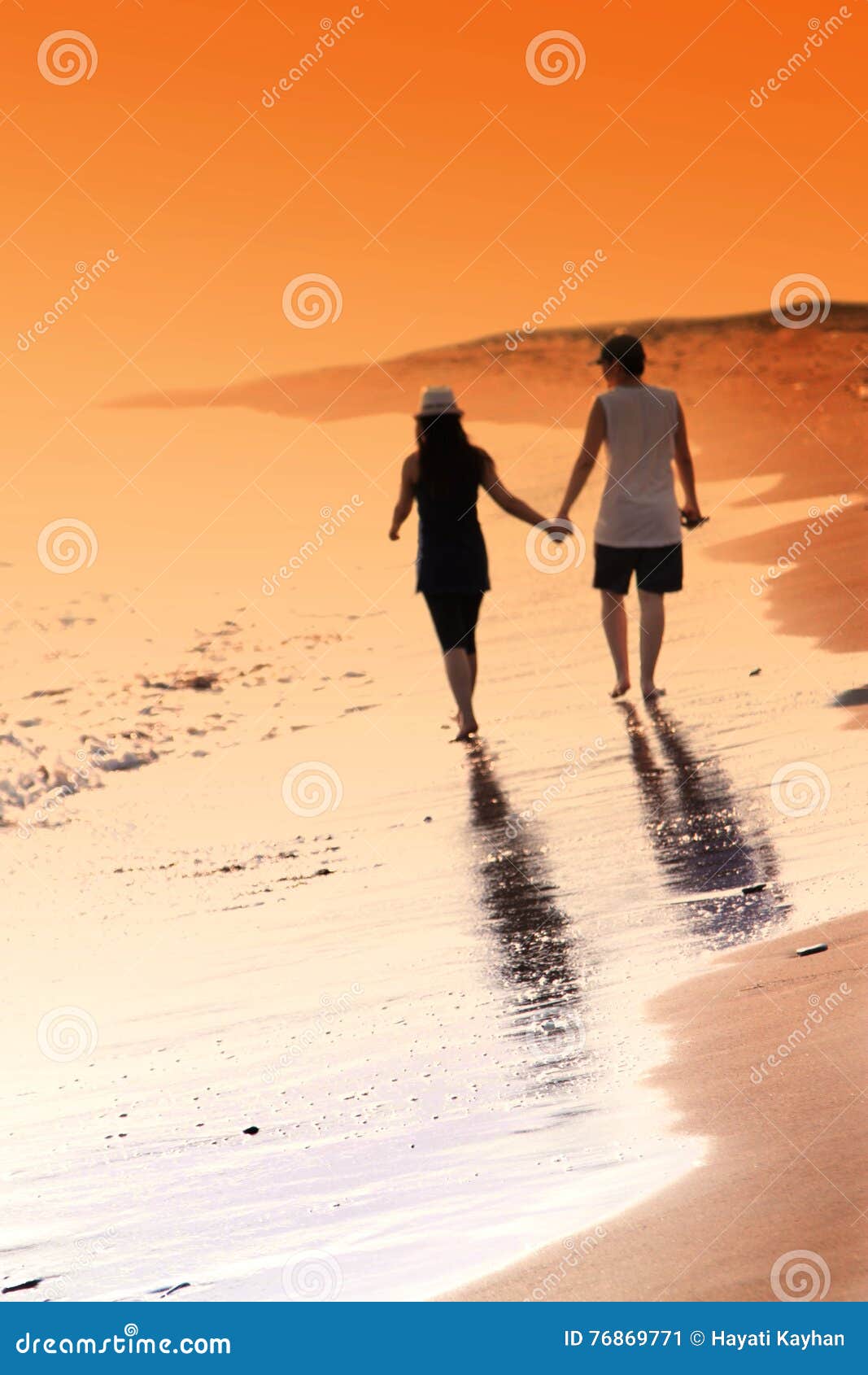 Young Woman And Man In Love Walking Hand In Hand On The