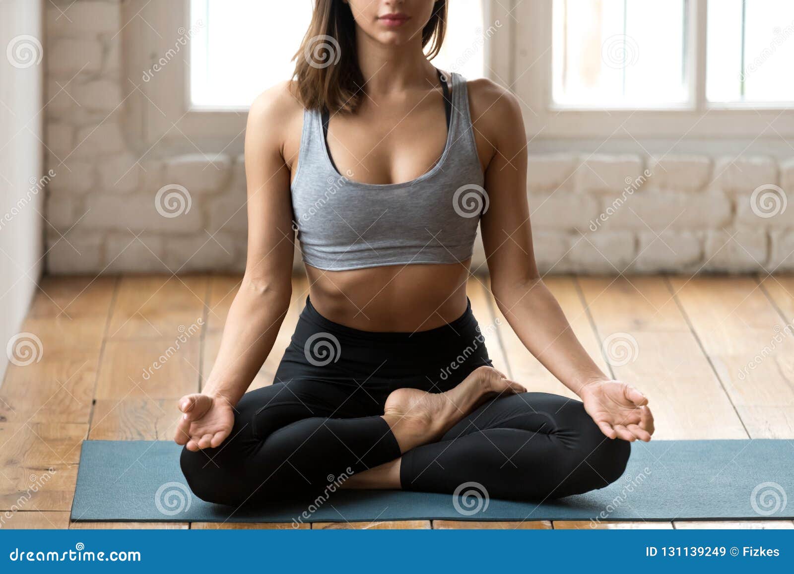Young Woman Meditating In Half Lotus Pose With Mudra Gesture Stock