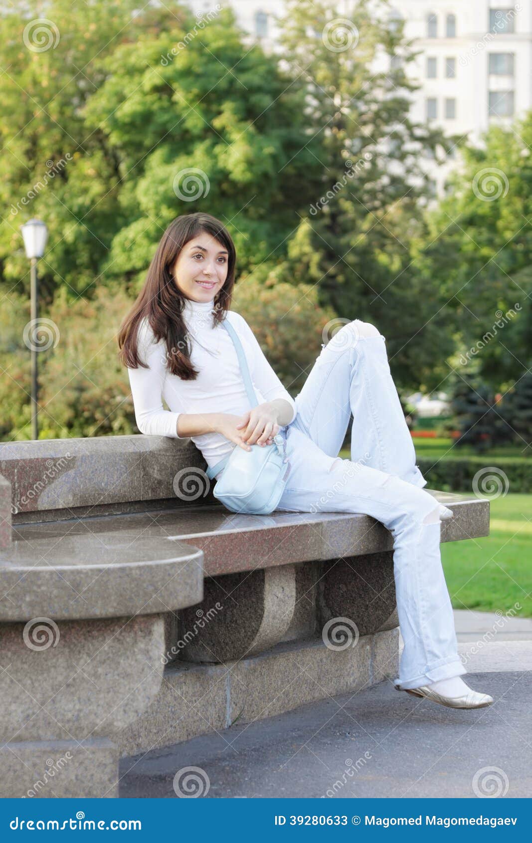 young woman in a park looking sideway