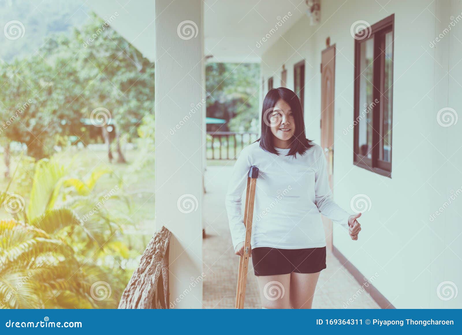 Young Woman Patient Using Crutches And Broken Leg For Walking In Young Woman Patient Using Crutches And Broken Leg For Walking In