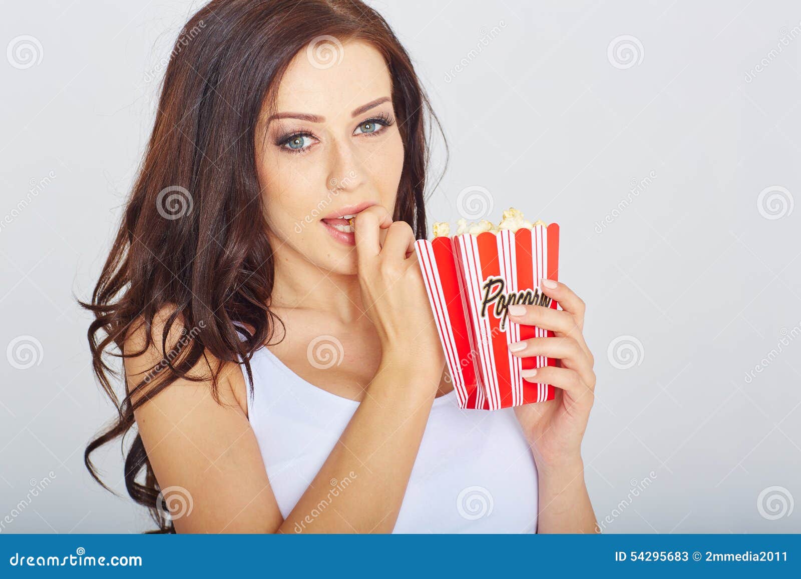 Young woman with popcorn stock image. Image of studio 54295683